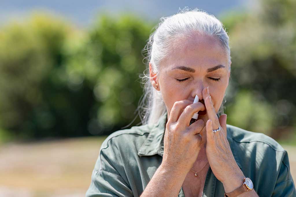 Yellowhead Cannabis Kamloops | Woman using nasal spray for allergy